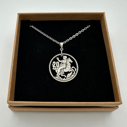 Greek Silver 20 Drachmai Hand Cut Coin Necklace in a brown kraft box on a black velvet background. - Mountainstruck Coin Jewelry