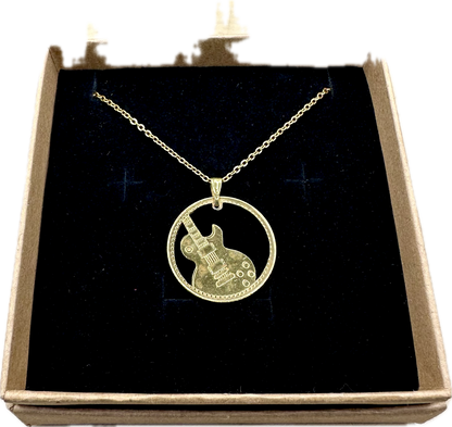Guitar Hand Cut Token Necklace in a brown kraft box on a black velvet background. - Mountainstruck Coin Jewelry