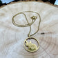 Guitar Hand Cut Token Necklace on a light wood round. - Mountainstruck Coin Jewelry