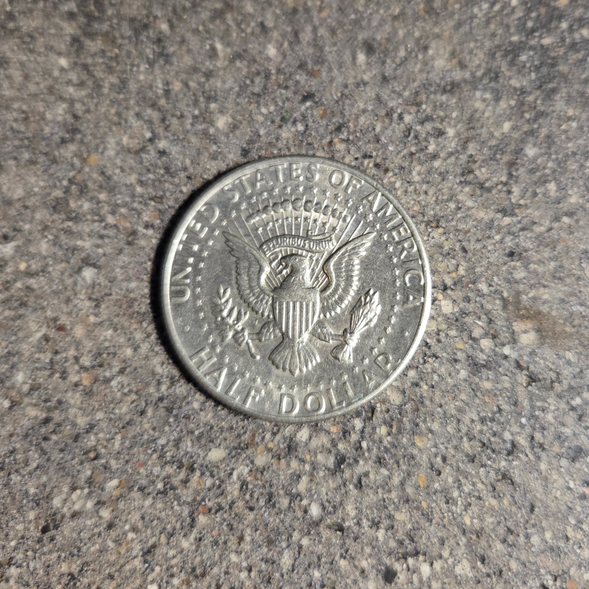 U.S. Half Dollar coin back on a concrete background. - Mountainstruck Coin Jewelry