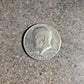 U.S. Half Dollar coin front on a concrete background. - Mountainstruck Coin Jewelry