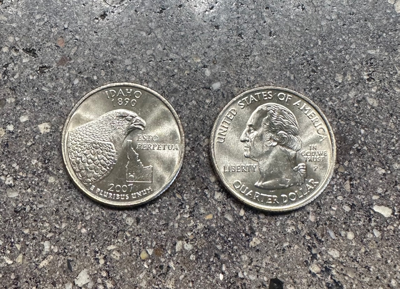 Idaho State Quarter on a concrete background. Back side of coin on the left of the image and front side of the coin on the right side.  - Mountainstruck Coin Jewelry