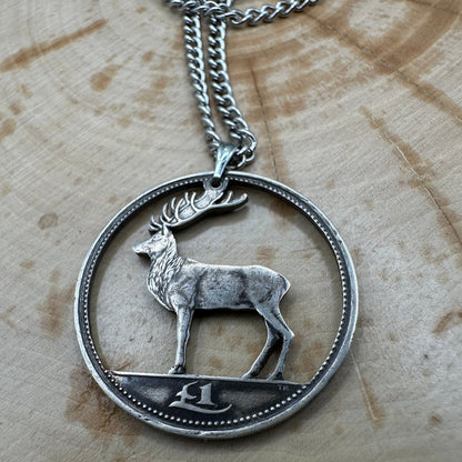 Irish Red Deer Hand Cut Coin Necklace on a wood background. - Mountainstruck Coin Jewelry