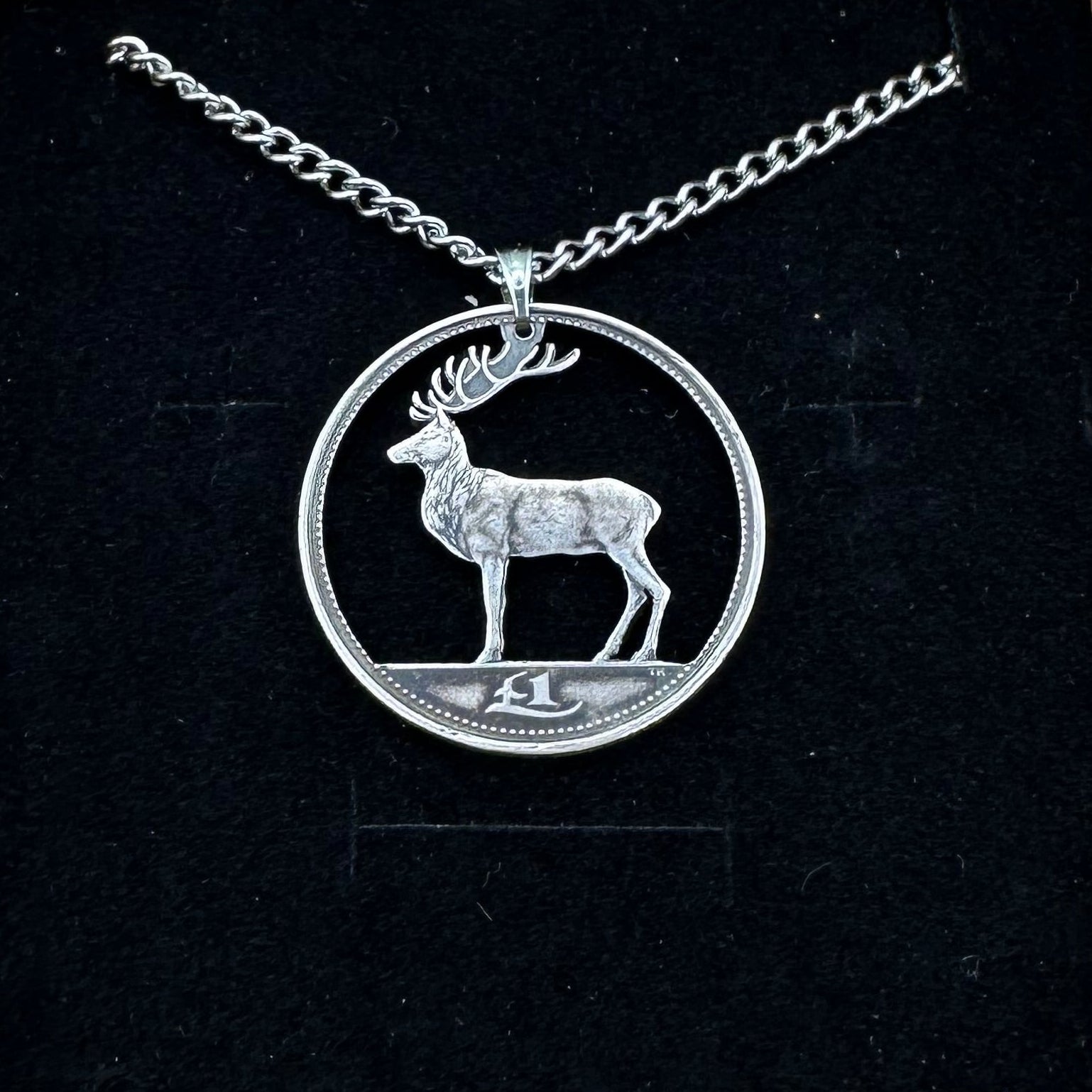 Irish Red Deer Hand Cut Coin Necklace on a black velvet background. - Mountainstruck Coin Jewelry