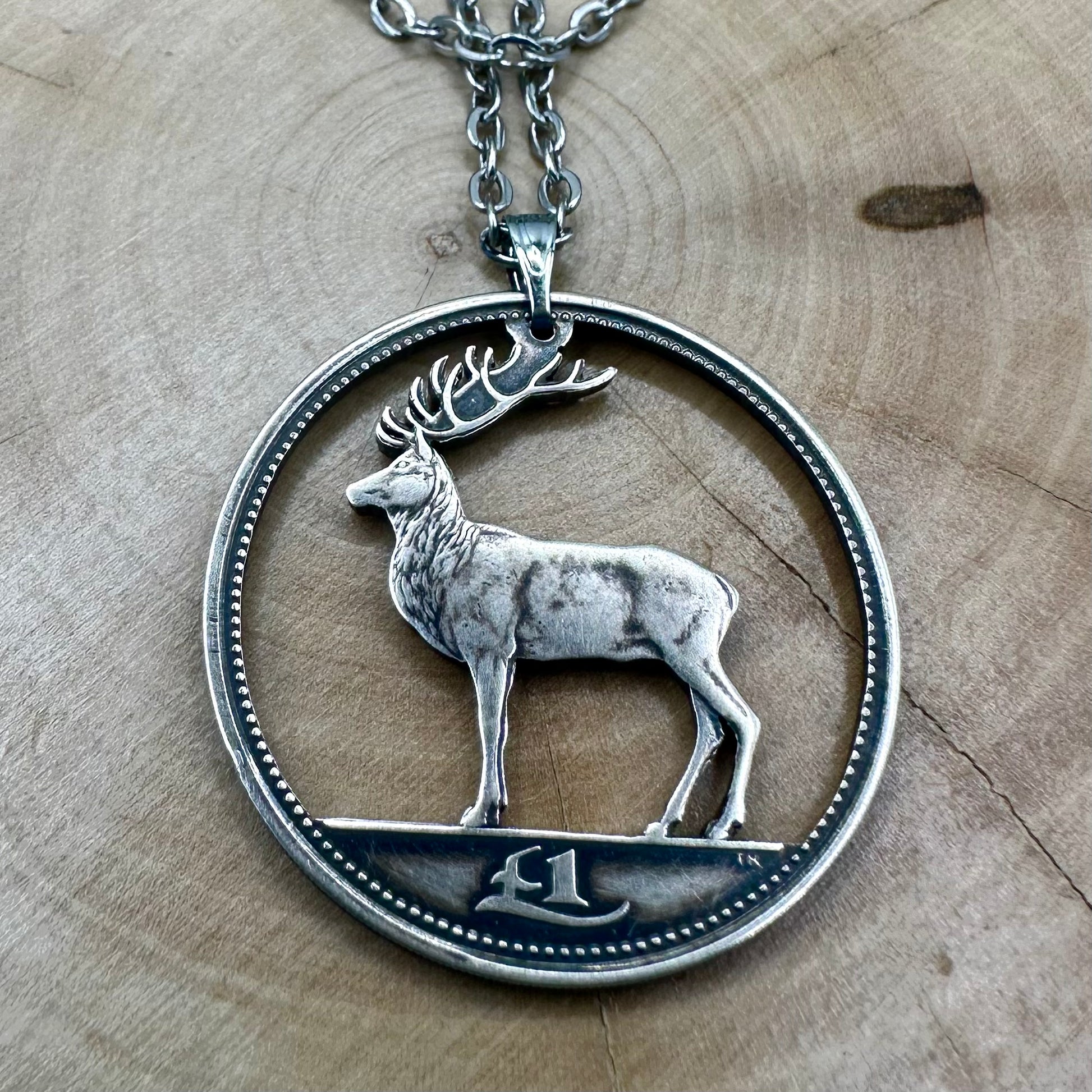 Ireland Red Deer Hand Cut Coin Necklace on a wood round. - Mountainstruck Coin Jewelry