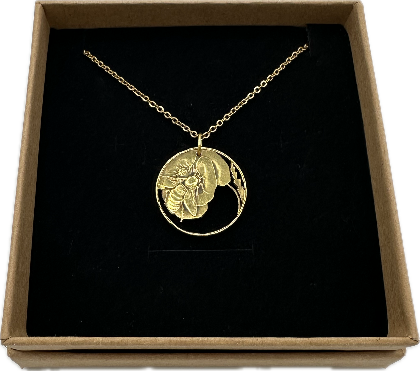Honeybee Italy 10 Centesimi Hand Cut Coin Necklace in a brown kraft box on a black velvet background. - Mountainstruck Coin Jewelry