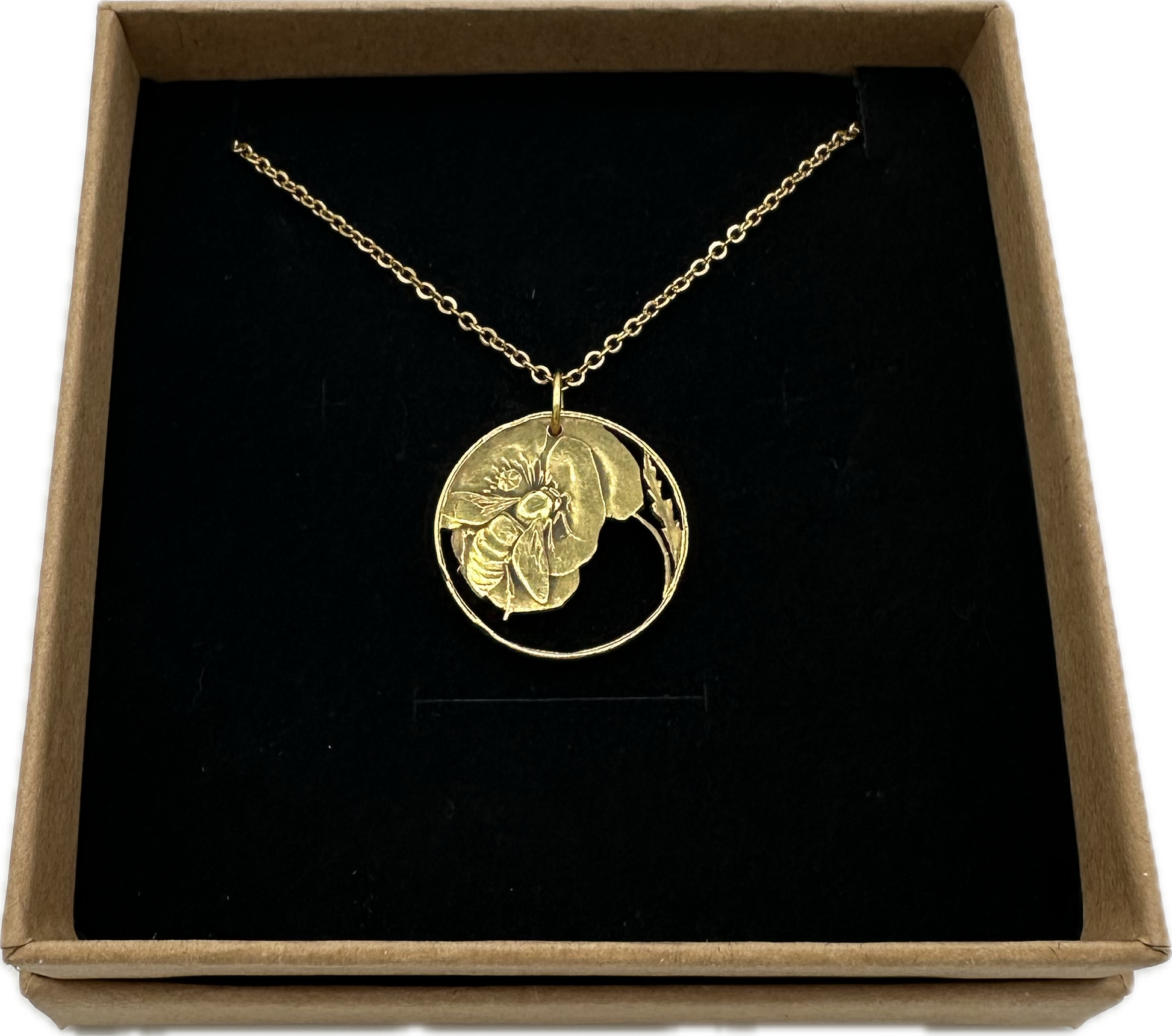 Honeybee Italy 10 Centesimi Hand Cut Coin Necklace in a brown kraft box on a black velvet background. - Mountainstruck Coin Jewelry