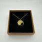 Italy Honeybee 10 Centesimi Hand Cut Coin Necklace in a brown kraft box on a black velvet background. - Mountainstruck Coin Jewelry