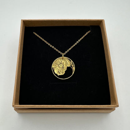 Italy Honeybee 10 Centesimi Hand Cut Coin Necklace in a brown kraft box on a black velvet background. - Mountainstruck Coin Jewelry