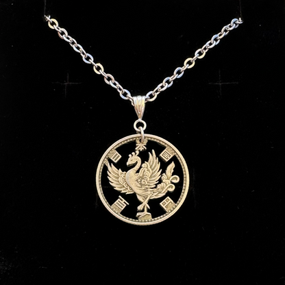 Japan Phoenix 100 Yen Silver Hand Cut Coin Necklace on a black velvet background. - Mountainstruck Coin Jewelry
