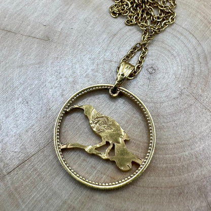 New Zealand Huia Bird 6 Pence Silver  24k Gold Plated Hand Cut Coin Necklace on a black velvet background. - Mountainstruck Coin Jewelry