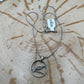 Huia Bird Silver New Zealand 6 Pence Hand Cut Coin Necklace on a black velvet background. - Mountainstruck Coin Jewelry