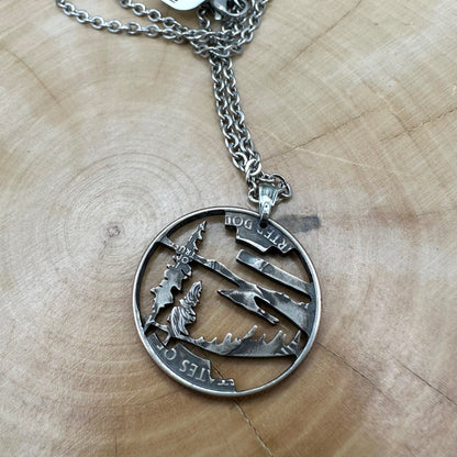 Oregon State Quarter Hand Cut Coin Necklace back with a stainless steel chain on a wood background. - Mountainstruck Coin Jewelry