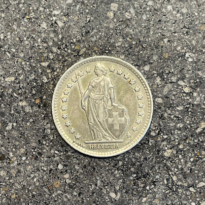Silver Lady Swiss 1 Franc Coin front on a concrete background.  - Mountainstruck Coin Jewelry