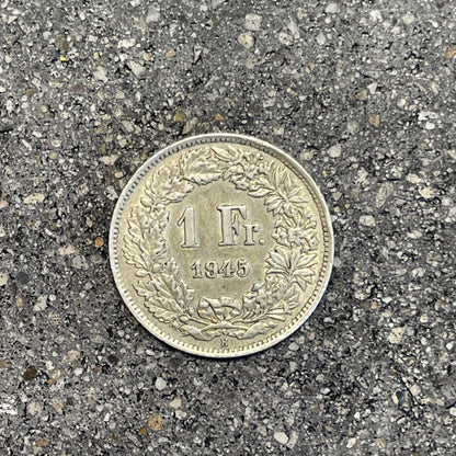 Silver Lady Swiss 1 Franc Coin back on a concrete background. - Mountainstruck Coin Jewelry