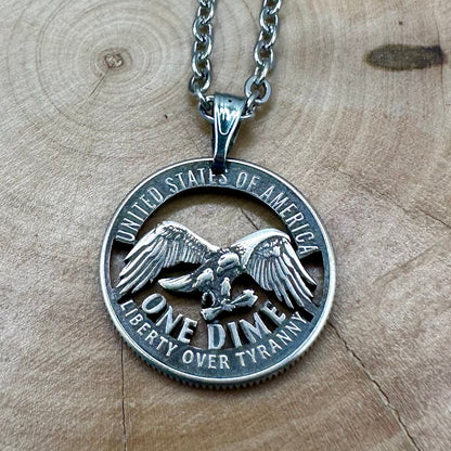 U.S. 2026 "Eagle" Dime Hand Cut Coin Necklace on a wood background. - Mountainstruck Coin Jewelry