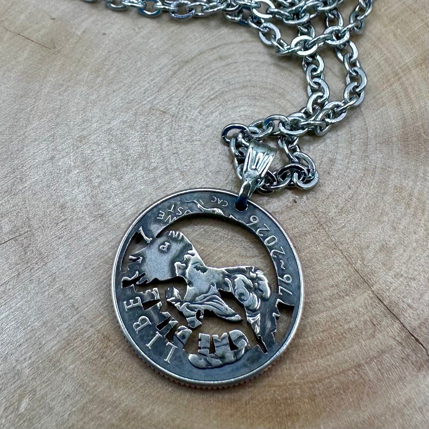 U.S. 2026 "Eagle" Dime Hand Cut Coin Necklace back on a wood background. - Mountainstruck Coin Jewelry