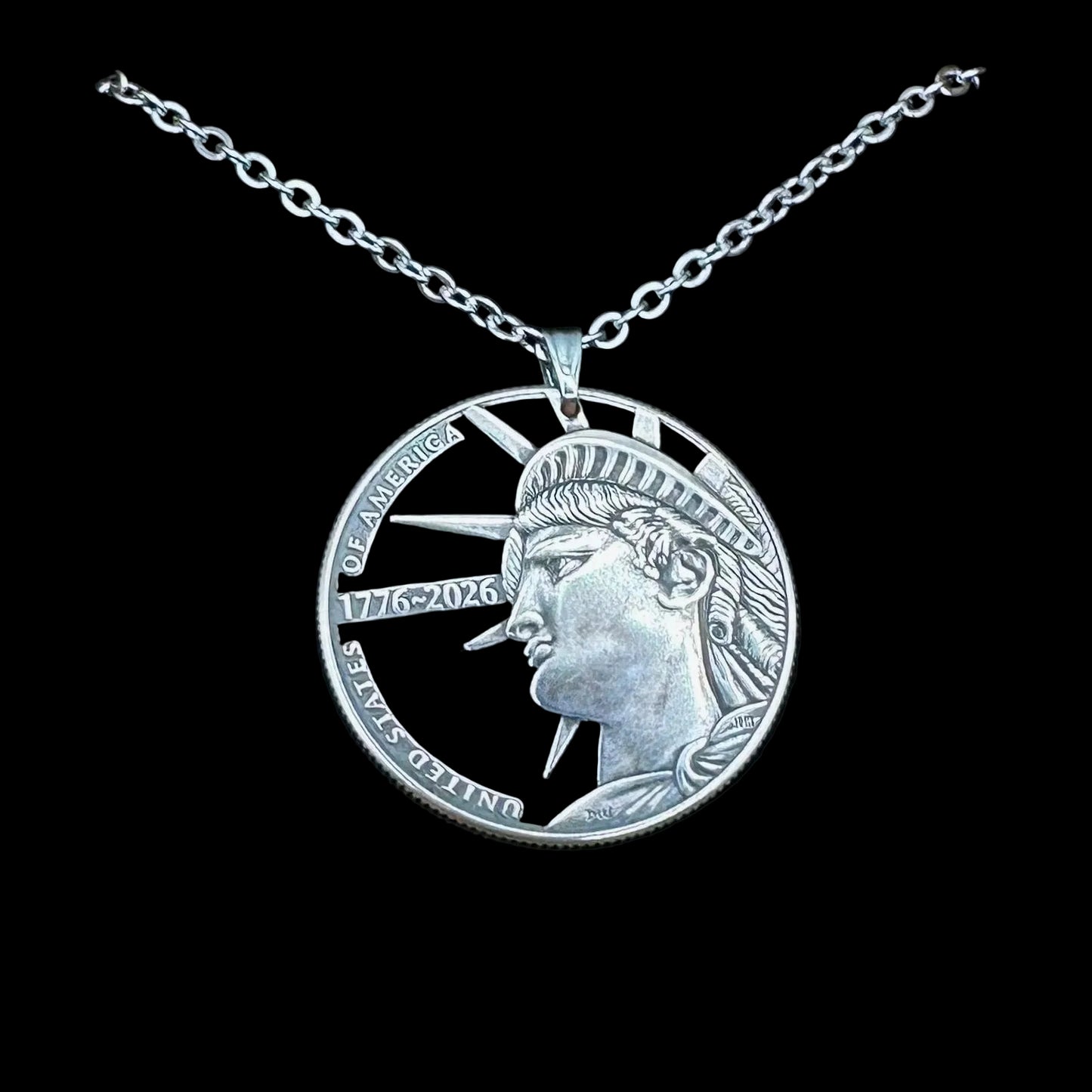 U.S. Half Dollar Hand Cut Coin Necklace (front) with a stainless chain on a black velvet background. - Mountainstruck Coin Jewelry