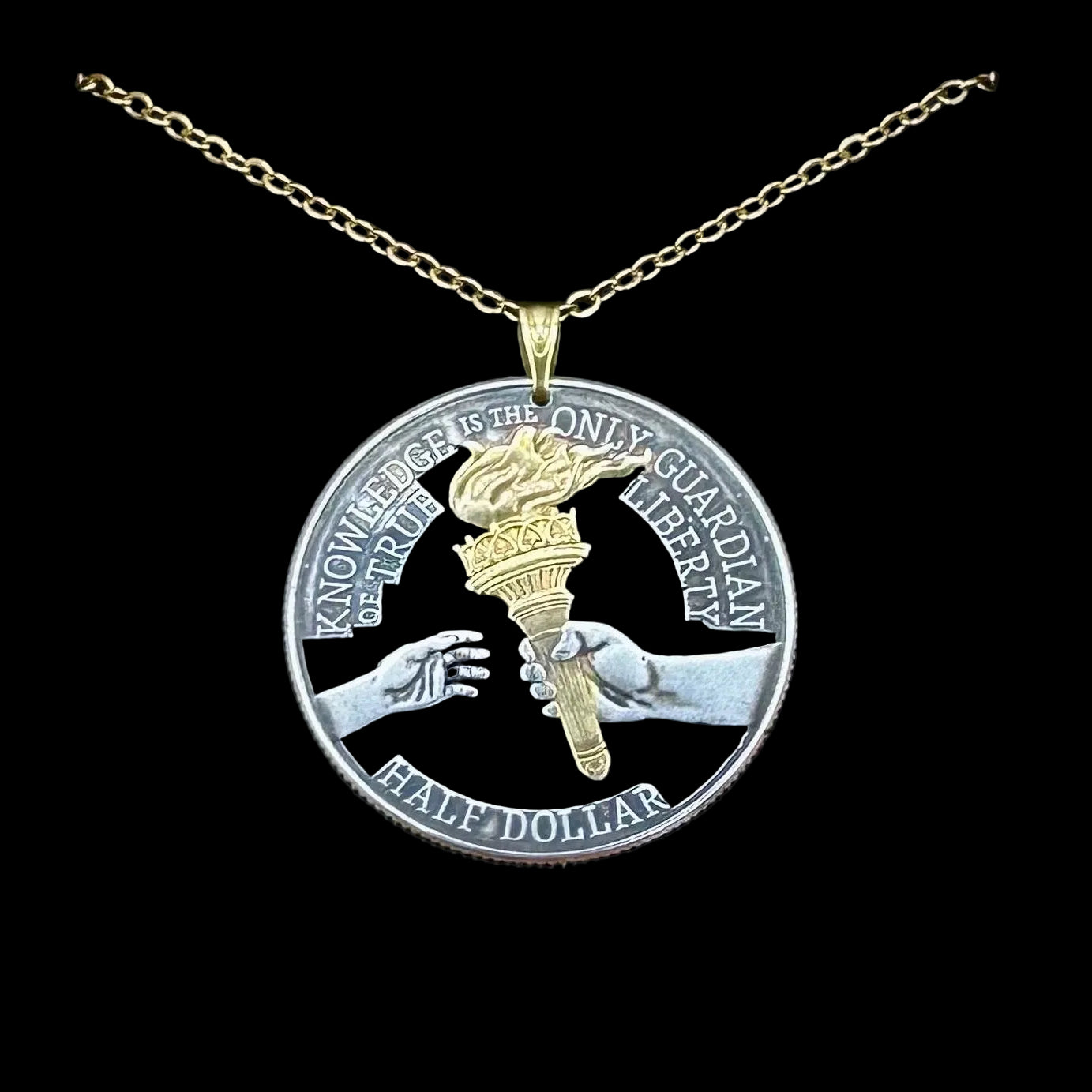U.S. 2026 Half Dollar Hand Cut Coin Necklace (reverse) 24k Gold Plated Torch with a gold plated chain on a black velvet background. - Mountainstruck Coin Jewelry