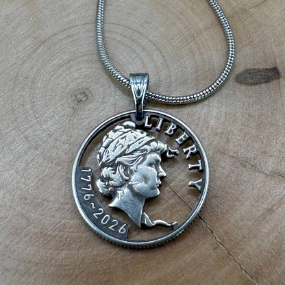 U.S. 2026 "Lady Liberty" Dime Hand Cut Coin Necklace on a wood background. - Mountainstruck Coin Jewelry