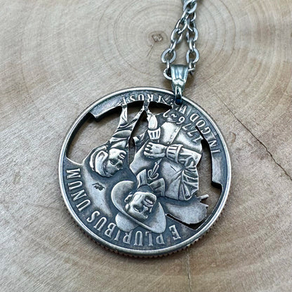 U.S. 2026 "Mayflower" Quarter Hand Cut Coin Necklace back with a stainless chain on a wood background. - Mountainstruck Coin Jewelry