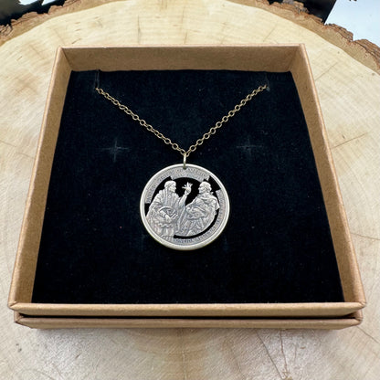 U.S. 2026 Oneida Allies 1 Dollar Hand Cut Coin Necklace with a bronze chain on a black velvet background in a brown kraft box on a wood round. - Mountainstruck Coin Jewelry