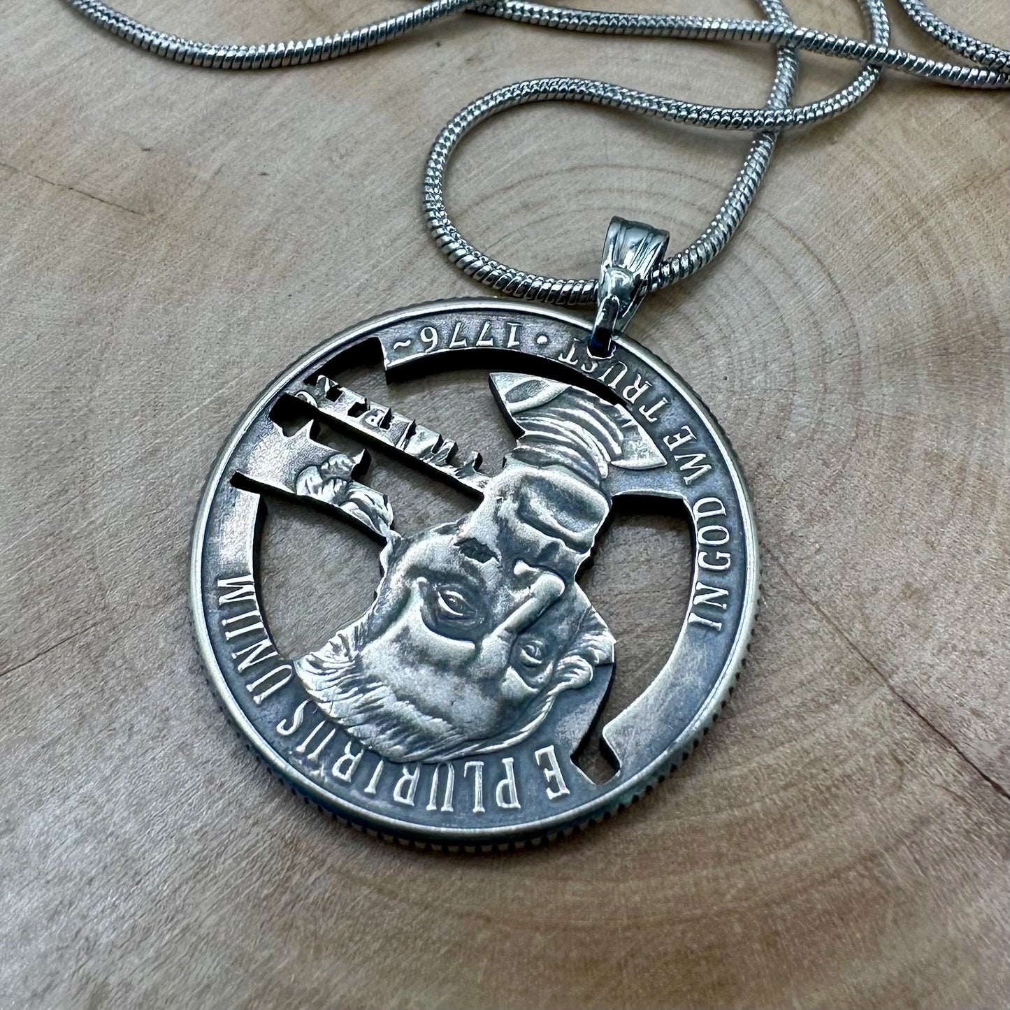 U.S. 2026 "Revolutionary War" Quarter Hand Cut Coin Necklace back with a snake chain on a wood background. - Mountainstruck Coin Jewelry