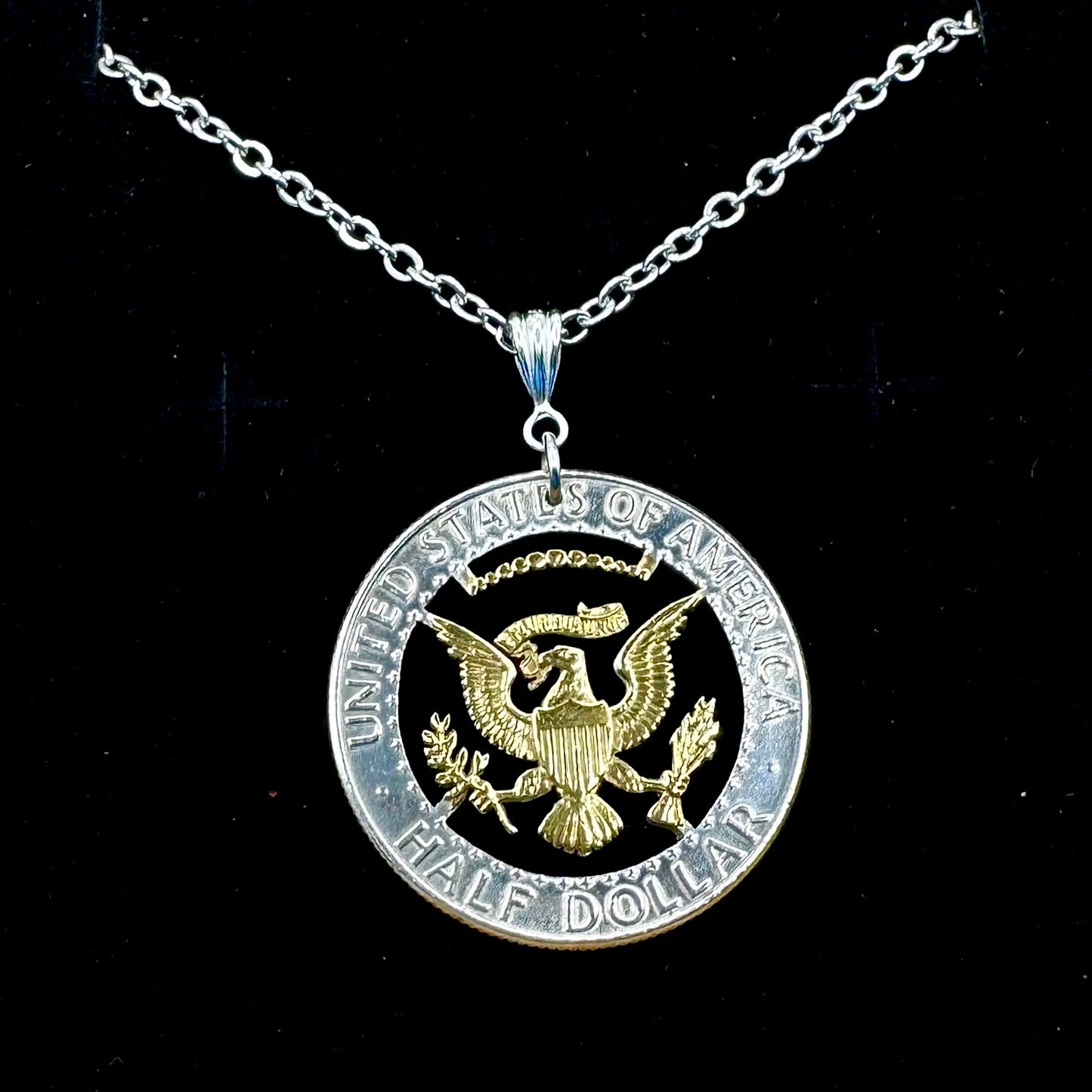 U.S. JFK Eagle Half Dollar Hand Cut Silver Coin Necklace with 24k gold plated Eagle on a black velvet background. - Mountainstruck Coin Jewelry