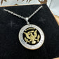U.S. JFK Eagle Half Dollar Hand Cut Silver Coin Necklace with 24k gold plated Eagle in a brown kraft box on a black velvet background with a metal mountain display. - Mountainstruck Coin Jewelry