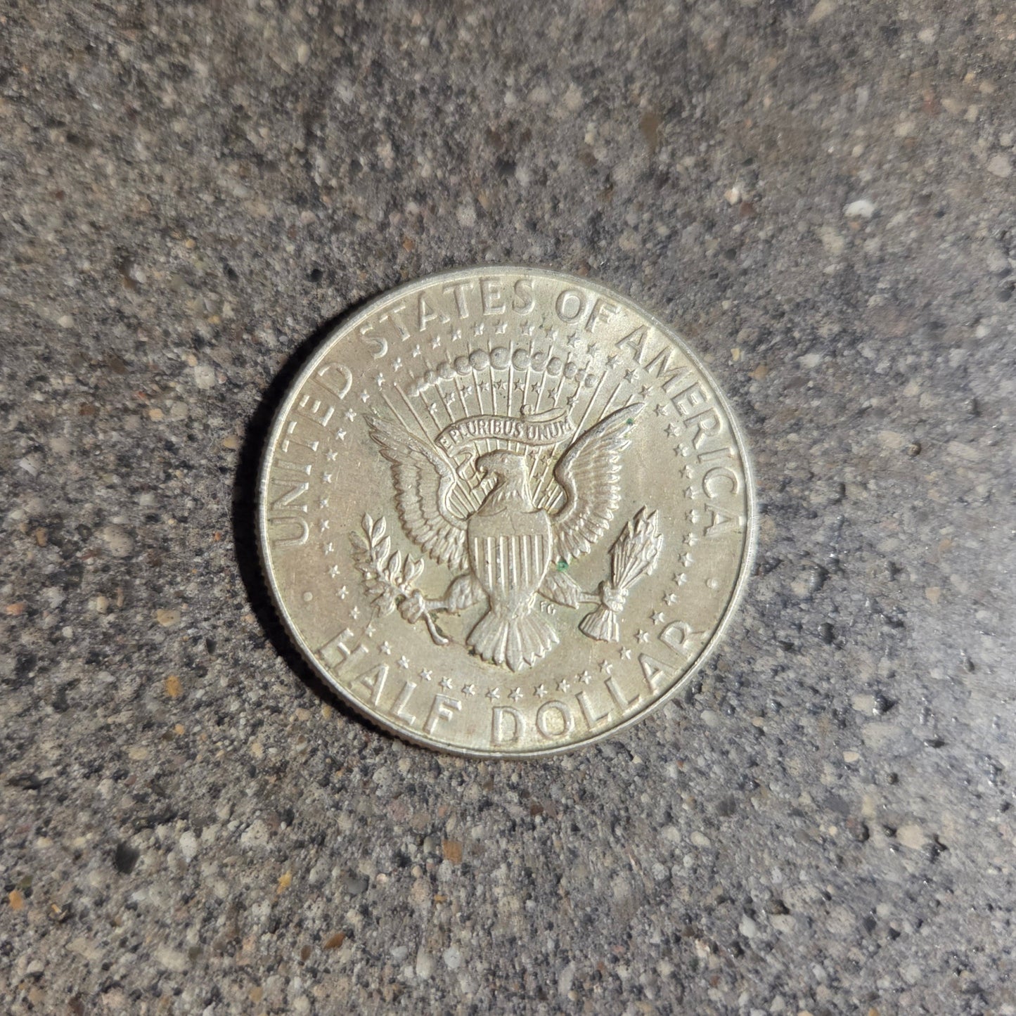 U.S. JFK Eagle Half Dollar Silver Coin back on a concrete background. - Mountainstruck Coin Jewelry