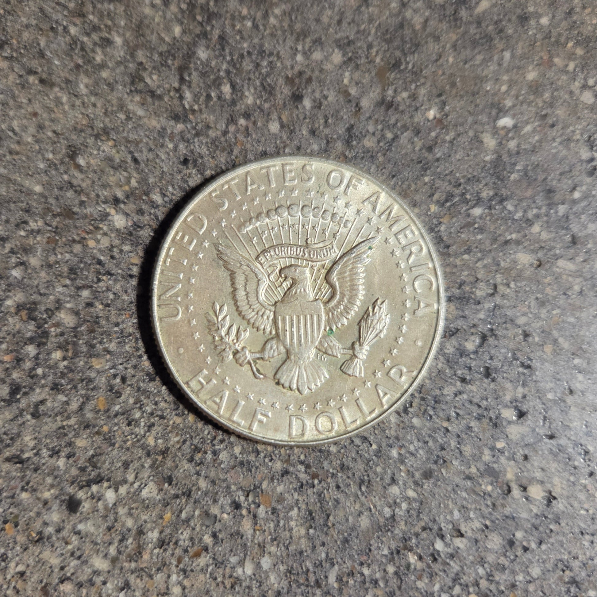 U.S. JFK Eagle Half Dollar Silver Coin back on a concrete background. - Mountainstruck Coin Jewelry