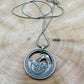 U.S. Arches National Park Hand Cut Coin Necklace back with snake chain on a light wood round. - Mountainstruck Coin Jewelry