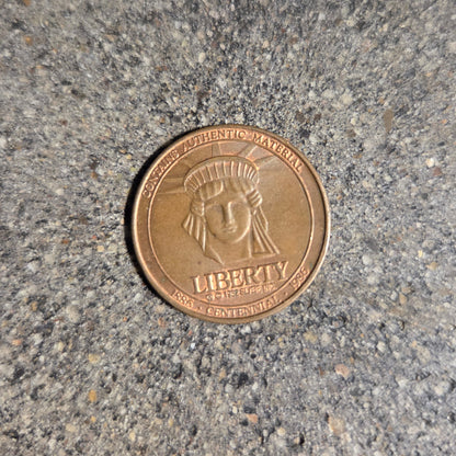 U.S. Authentic Copper Statue of Liberty Token coin front on a concrete background. - Mountainstruck Coin Jewelry