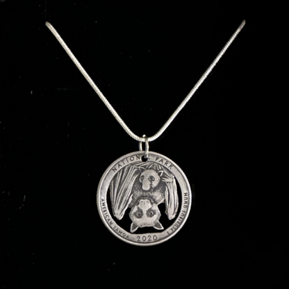 U.S. Bat National Park Quarter Hand Cut Coin Necklace on a black velvet background. - Mountainstruck Coin Jewelry