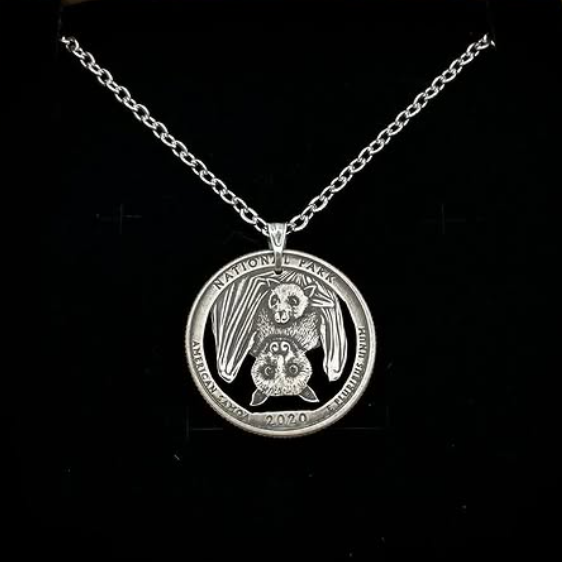 U.S. Bat National Park Quarter Hand Cut Coin Necklace on a black velvet background. - Mountainstruck Coin Jewelry