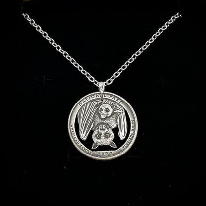 U.S. Bat National Park Quarter Hand Cut Coin Necklace on a black velvet background. - Mountainstruck Coin Jewelry