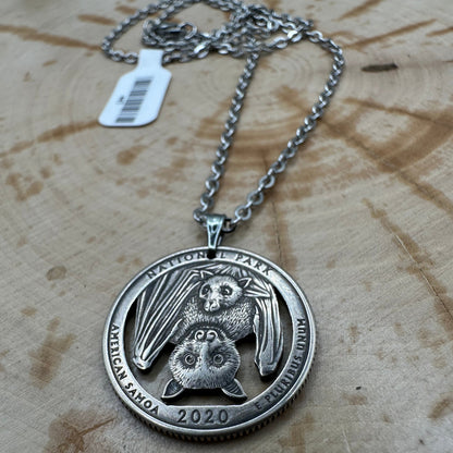 U.S. Bat National Park Quarter Hand Cut Coin Necklace on a wood background. - Mountainstruck Coin Jewelry