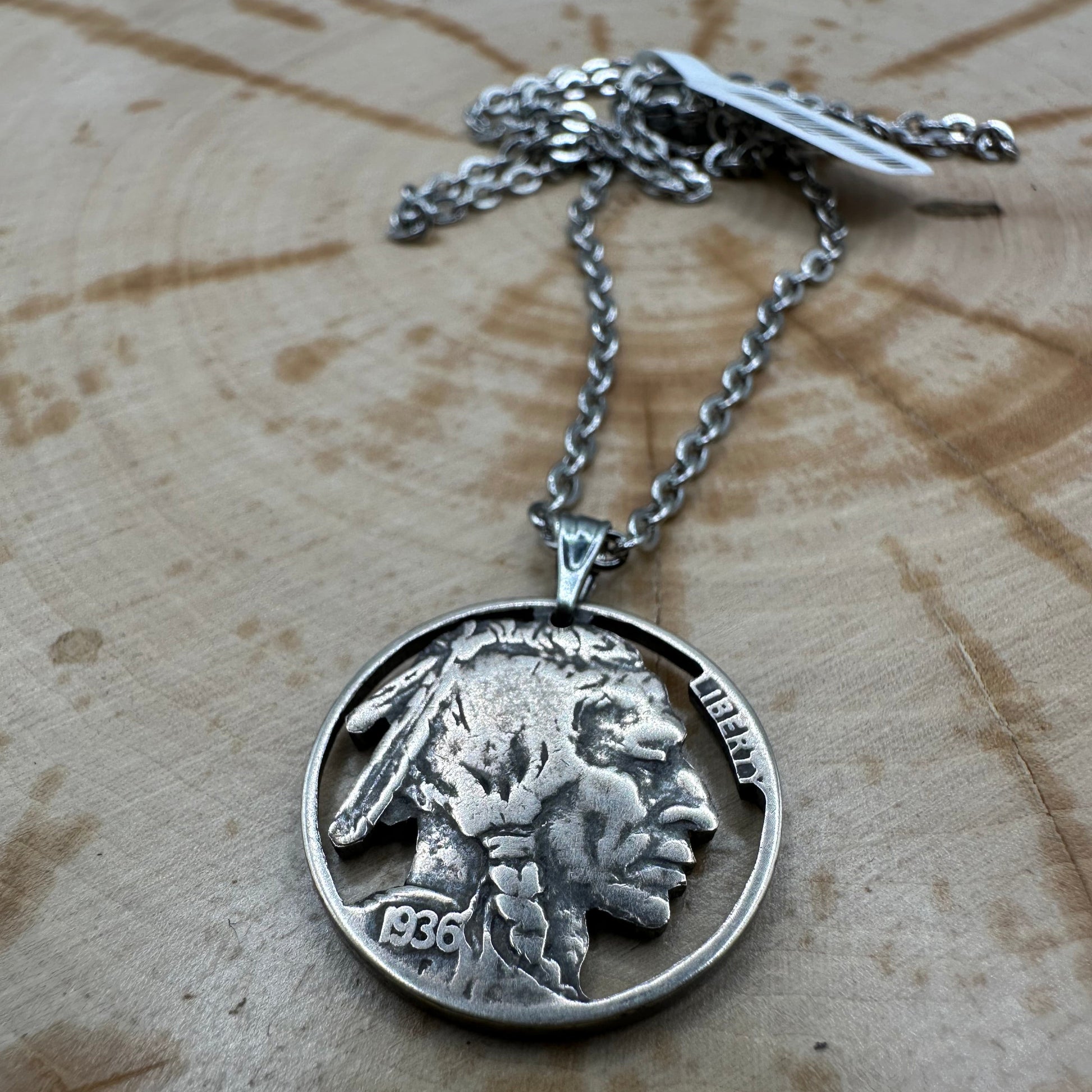 U.S. Buffalo Nickel Hand Cut Coin Necklace (Front) with a snake chain  on wood background. - Mountainstruck Coin Jewelry