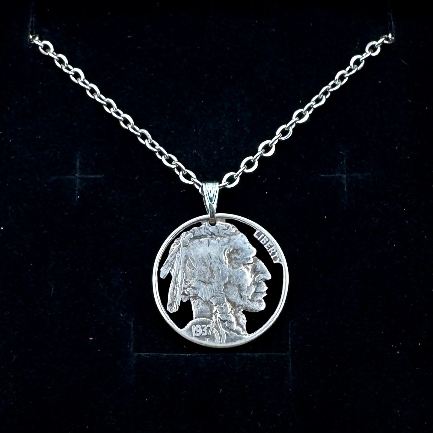 U.S. Buffalo Nickel Hand Cut Coin Necklace (Front) with a stainless chain  on black velvet background. - Mountainstruck Coin Jewelry