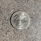 U.S. Butterfly Tallgrass Prairie Quarter Coin back on a concrete background - Mountainstruck Coin Jewelry