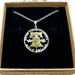 U.S. Cracked Liberty Bell Half Dollar Hand Cut Coin Necklace 24k Gold Plated Bell with a stainless chain in a brown kraft box on a black velvet background. - Mountainstruck Coin Jewelry