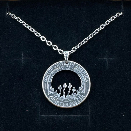 U.S. Custom Mushroom Quarter Hand Cut Coin Necklace with stainless chain on a black velvet background.- Mountainstruck Coin Jewelry