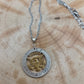 U.S. Eagle Half Dollar Hand Cut Silver Coin Necklace with 24k gold plated eagle on a wood background. - Mountainstruck Coin Jewelry