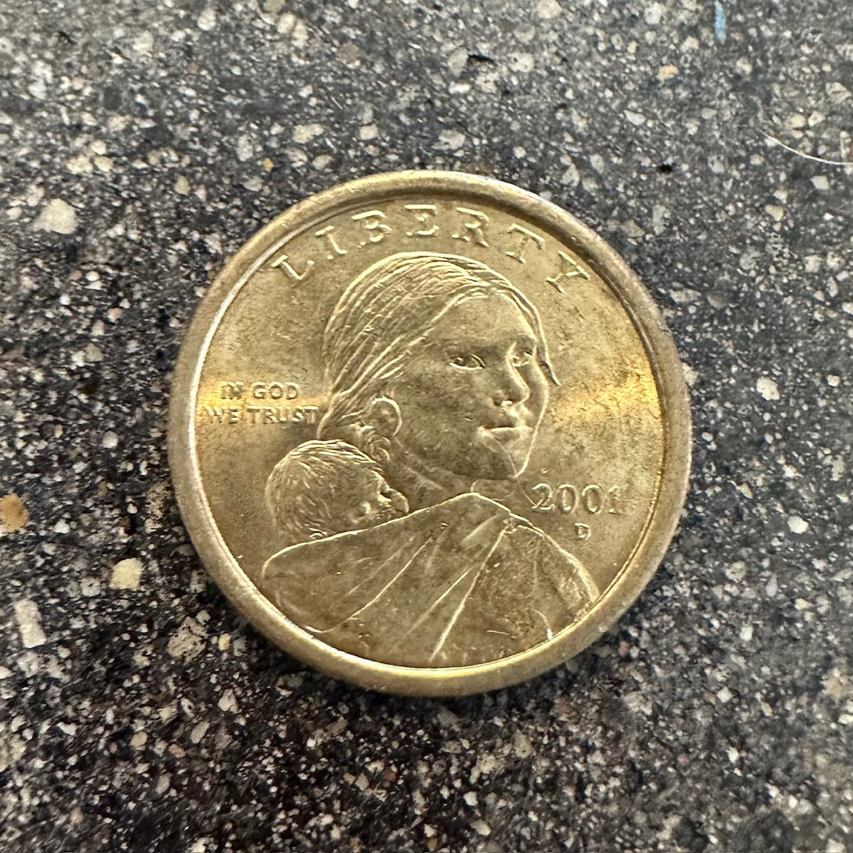 U.S. Flying Eagle Sacagawea One Dollar Coin front on a concrete background. - Mountainstruck Coin Jewelry