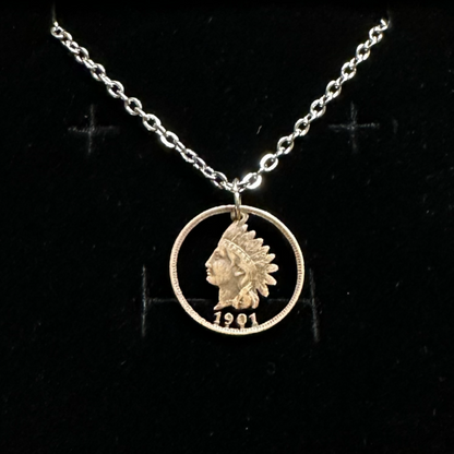 U.S. Indian Head Penny Hand Cut Coin Necklace with a stainless chain in a brown kraft box on a black velvet background. - Mountainstruck Coin Jewelry