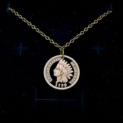 U.S. Indian Head Penny Hand Cut Coin Necklace with a stainless chain on a black velvet background. - Mountainstruck Coin Jewelry