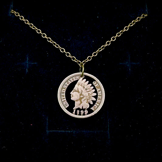 U.S. Indian Head Penny Hand Cut Coin Necklace with a stainless chain on a black velvet background. - Mountainstruck Coin Jewelry