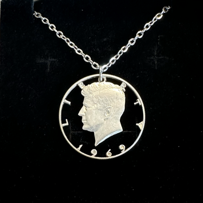 U.S. JFK Half Dollar Hand Cut Silver Coin Necklace with stainless chain in a brown kraft box on black velvet background. - Mountainstruck Coin Jewelry