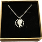 U.S. Mercury Dime Silver Hand Cut Coin Necklace (stainless chain) in a brown kraft box on a black velvet background. - Mountainstruck Coin Jewelry