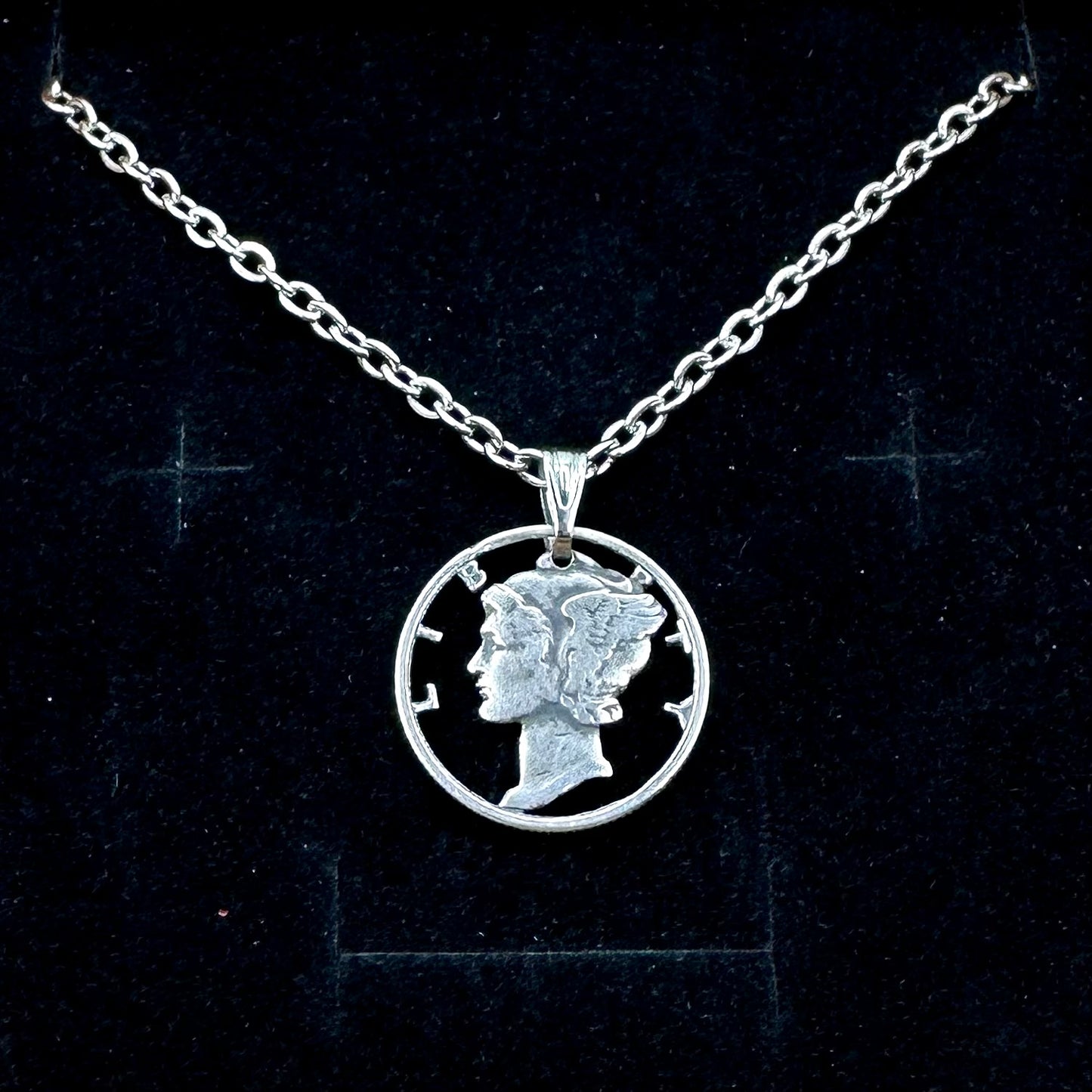 U.S. Mercury Dime Silver Hand Cut Coin Necklace (stainless chain) in a brown kraft box on a black velvet background. - Mountainstruck Coin Jewelry